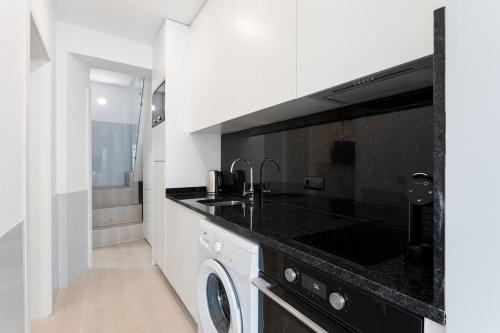 a kitchen with a sink and a dishwasher at Authentic Retreat by HostWise in Porto