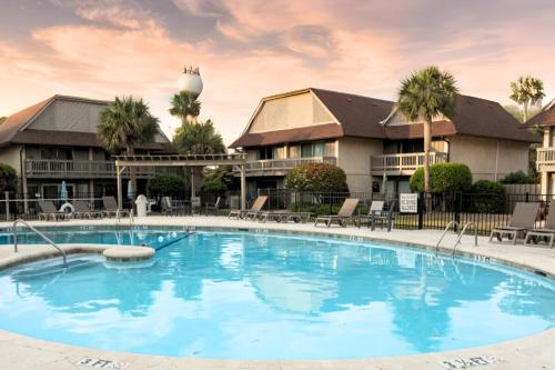 a large swimming pool in front of a resort at Pool - Ocean View - Walk to Beach - Captain Villa in Fripp Island