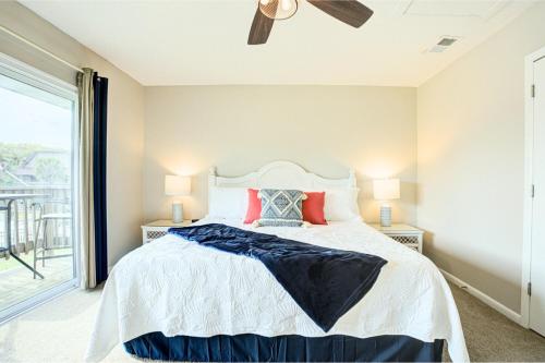 a bedroom with a large bed with red pillows at Pool - Ocean View - Walk to Beach - Captain Villa in Fripp Island