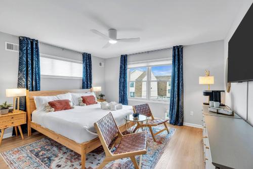 a bedroom with a large bed with blue curtains at 127 Fremont in Seaside Heights