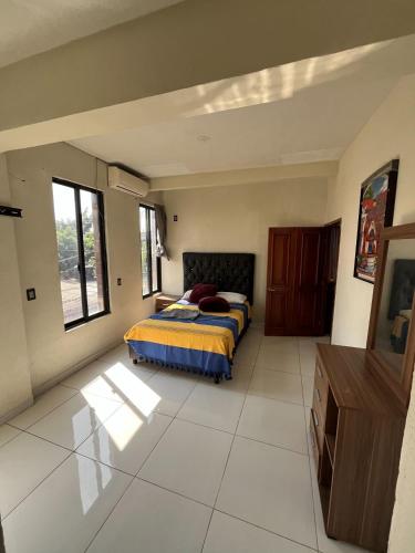 a bedroom with a bed and a tv in it at Departamento en Cuernavaca in Cuernavaca