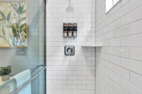 a bathroom with a shower with white tiles at 127 Fremont in Seaside Heights