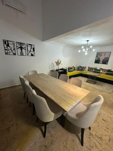 a dining room with a wooden table and chairs at Gueliz Appartement in Marrakesh