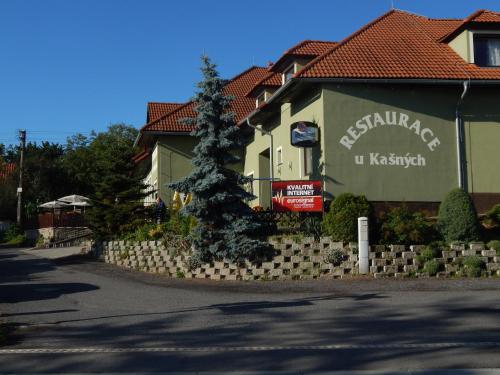 a building with a sign on the side of it at Penzion U Kašných in Mníšek pod Brdy