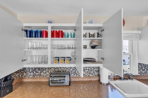 a kitchen with white cabinets and a sink at 209 4th Ave in Seaside Heights