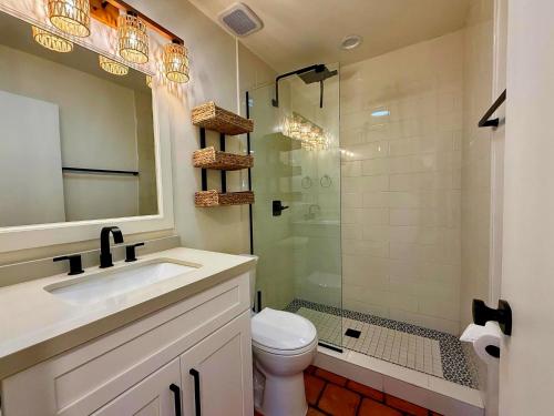 a bathroom with a toilet and a sink and a shower at The Casita Collective in Scottsdale