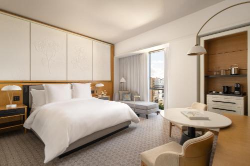 a hotel room with a bed and a desk at Four Seasons New Orleans in New Orleans