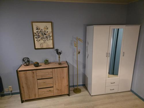 a room with a wooden dresser and a door at La Mésange Apprivoisée in Vresse-sur-Semois