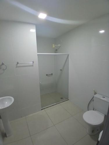 a white bathroom with a shower and a toilet at GoldMen Express Campos Goytacazes in Campos dos Goytacazes