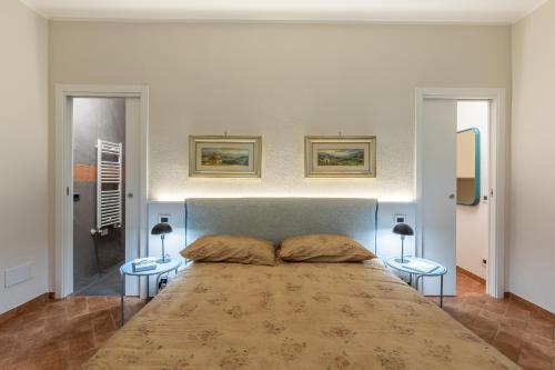 a bedroom with a large bed with two tables at Nidin Apartments in Cassano Spinola