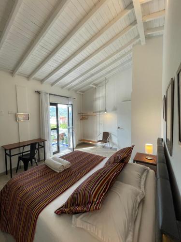 a bedroom with a large bed and a table at Hotel Casa Azul Jardín in Jardin