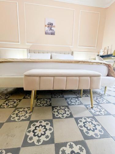 a large bed in a room with a checkerboard floor at Flame B&B in Catania