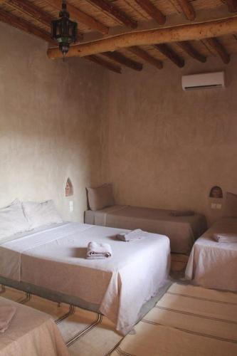 Llit o llits en una habitació de Auberge Migusta