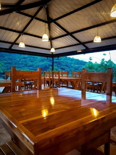 a large wooden table in a room with benches at Ecolodge Ix Cacao in San Carlos