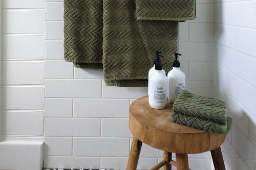 two bottles sitting on a stool in a bathroom at Sage in Glenlyon