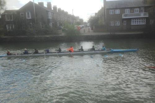 a group of people in a row boat on the water at Thames Side Flat in Oxford