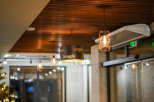 a sign that says hooters lunch hanging from a ceiling at Steel Tower Borjomi in Borjomi