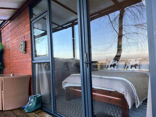 a room with a glass door with a view of a table at The Cabin in the Woods in Dublin
