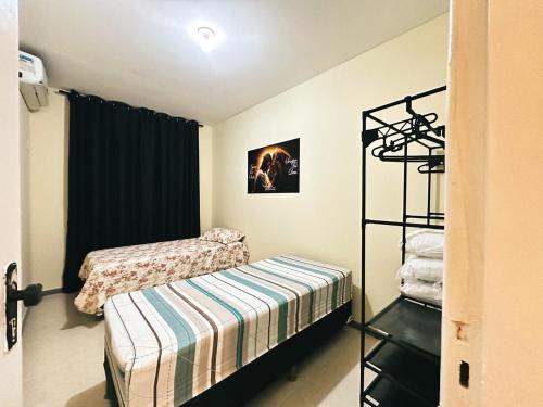 En eller flere senge i et værelse på Condomínio Orla de Atalaia