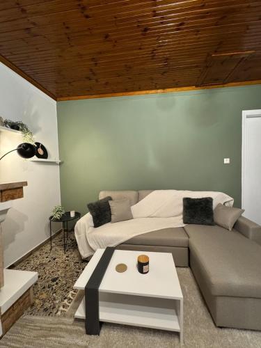 a living room with a couch and a coffee table at Eftychia's House in Marioláta