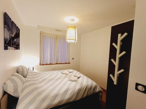 a bedroom with a bed and a chandelier at Escale au Nord in Dunkerque