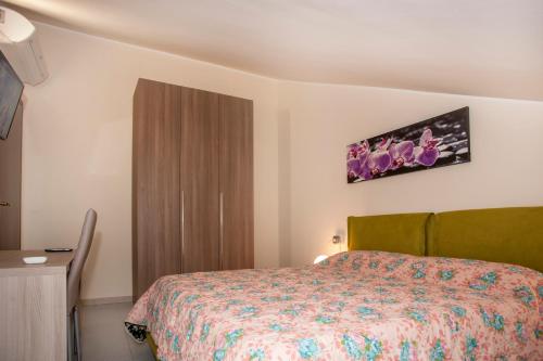 a small bedroom with a bed and a cabinet at B&B Villa Aurora in Brugherio