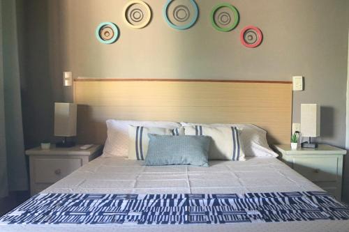 a bedroom with a bed with plates on the wall at Posada Casa Tortuga, Zipolite in Zipolite