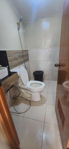 a bathroom with a toilet and a sink at Welcome Home, whole 2 bedroom unit - VCDU Riverview, Mabini Plains in Mabini