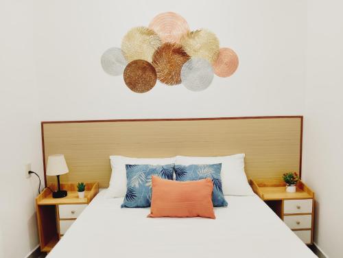 a bedroom with a large white bed with a headboard at Posada Casa Tortuga, Zipolite in Zipolite