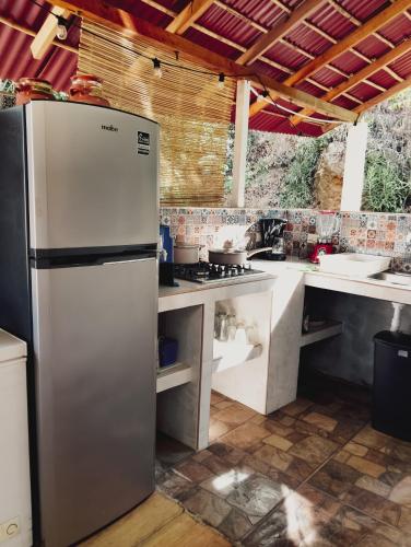 a kitchen with a refrigerator and a stove at Posada Casa Tortuga, Zipolite in Zipolite