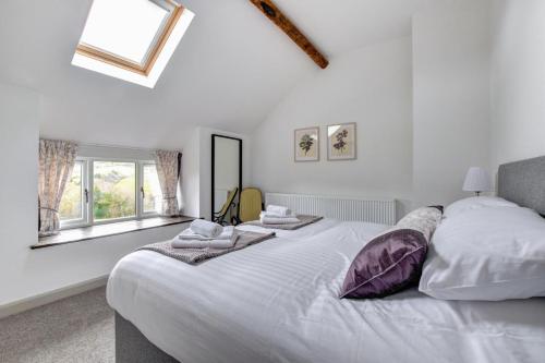 a bedroom with a large white bed with towels on it at 2 Bed in Machynlleth oc-bow39 in Darowen