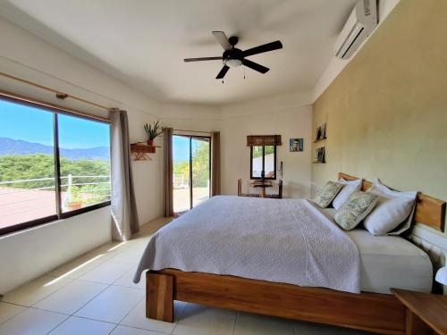 a bedroom with a bed and a ceiling fan at La Casa del Conde in Playa Naranjo