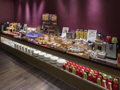 a buffet line with a lot of food on display at Mercure Kunshan Hi Tech Zone in Kunshan