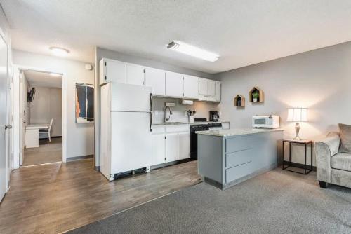 een keuken met een witte koelkast en een bank bij Second-floor - Riverfront Condo Near Downtown Bend in Bend