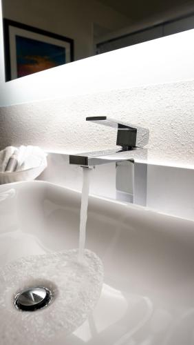 a white sink with a faucet in a bathroom at Bandon Inn in Bandon