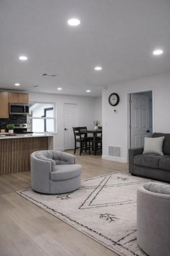a living room with two couches and a kitchen at Spacious Casselberry Home Near Attractions in Orlando