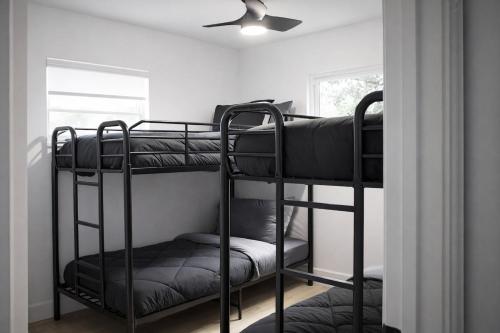 two bunk beds in a room with a ceiling fan at Spacious Casselberry Home Near Attractions in Orlando
