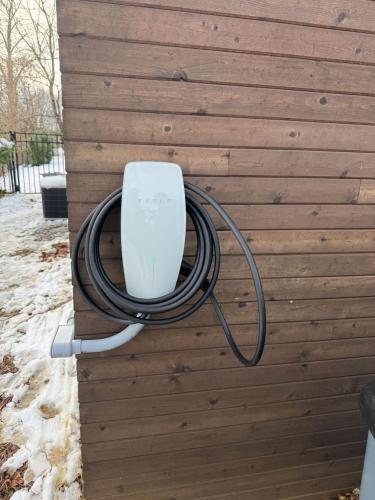 a hose is hooked up to a wall at Modern Mid-Century Retreat in West Chester