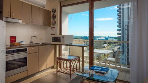 a kitchen with a counter and a large window at Broadbeach Savannah Resort in Gold Coast