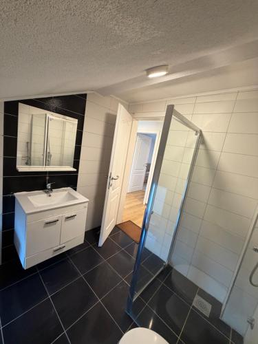 a bathroom with a sink and a toilet and a mirror at White Villa Blažuj in Blažuj