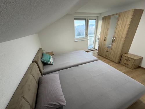 a bedroom with a large bed and a window at White Villa Blažuj in Blažuj