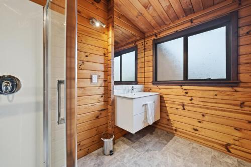 a bathroom with a toilet and a sink and a shower at The Wee Glen - Peaceful Country Retreat 2 bed in Bennetts