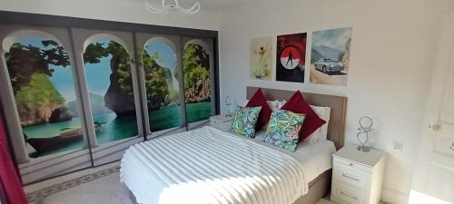 een slaapkamer met een bed en grote ramen bij Place of the Goddess in Damvillers