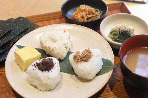 a plate of sushi and other foods on a table at HOTEL Enmichi in Kawasaki
