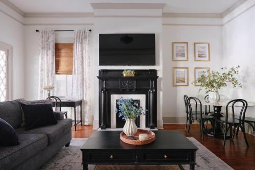 a living room with a couch and a fireplace at Comfortable Escape in Historic Downtown Savannah in Savannah