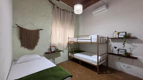 a bedroom with two bunk beds and a window at Ankaa Hostel in Flores