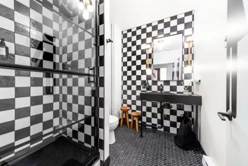 a black and white bathroom with a toilet and a sink at Symons Block Suite 5 in Spokane