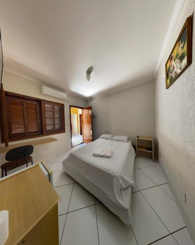 a bedroom with a bed and a table in a room at Hotel Reimann in Indaiatuba