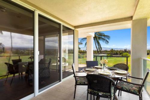 a dining room with a table and chairs on a patio at Peaceful condo with lanai & beach essentials in Waikoloa
