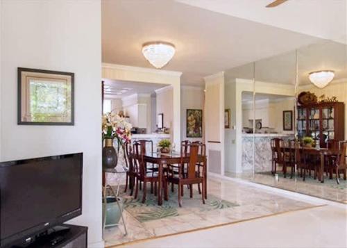 a dining room and kitchen with a table and chairs at Golf-view condo with golf discounts & lanai in Waikoloa